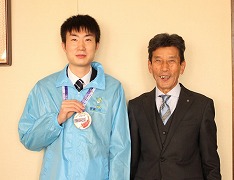 メダルを手に市長と記念撮影をする山田さんの写真